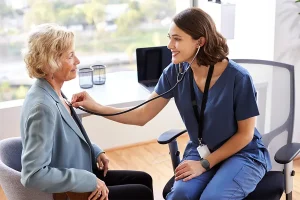 Home Healthcare nurse checking heart rate of patient