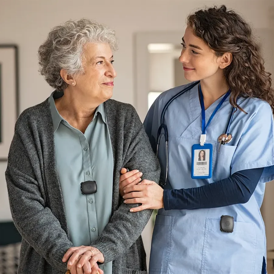 nurse walking with patient and silent beacon panic buttons on their clothing.